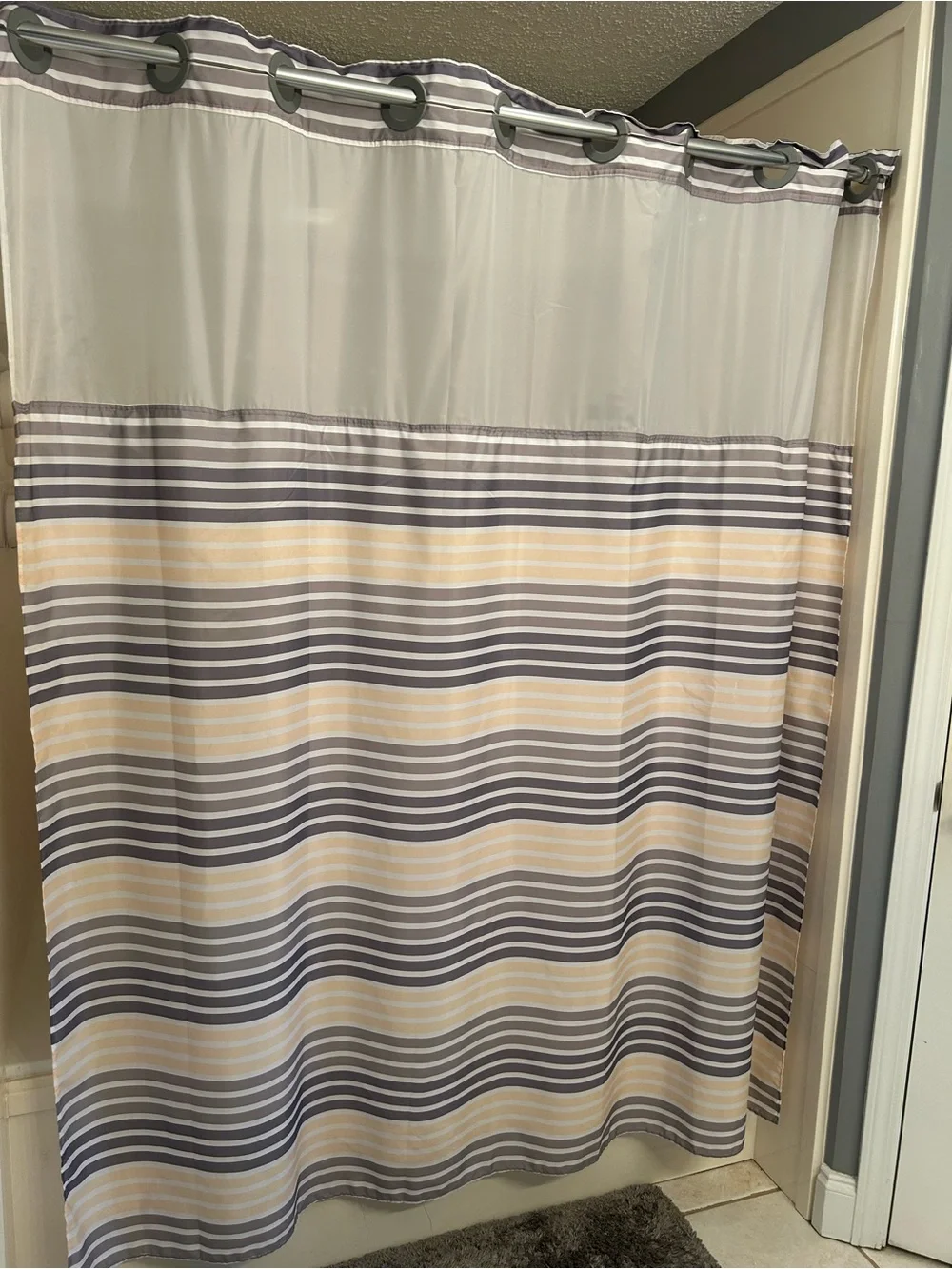 Striped Hookless Shower Curtain in Gray, white and yellow stripes.